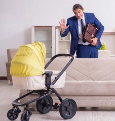 Young businessman looking after baby