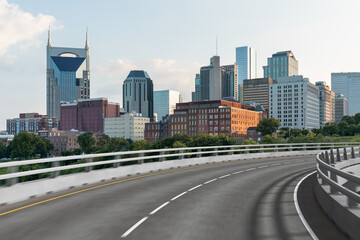 Fototapeta na wymiar Empty urban asphalt road exterior with city buildings background. New modern highway concrete construction. Concept of way to success. Transportation logistic industry fast delivery. Nashville. USA.