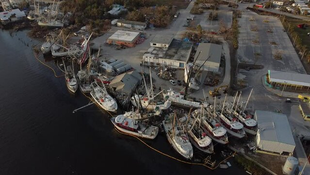 Fishing boats mangled with one another while sitting on dry land after being pushed from the Matanzas Pass on Fort Myers Beach, FL by Hurricane Ian's historic storm surge. 