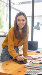 Closeup hand signing or using a digital pen on a computer tablet on the desk, a businesswoman use a...
