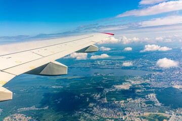 View from the airplane window during taking off on a clear summer morning. Yekaterinburg, Russia