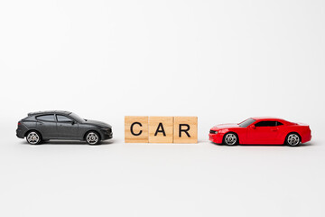 CAR wooden text with red sedan and black SUV cars with copy space on white background