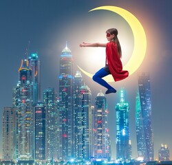 Superhero kid sitting on the moon crescent