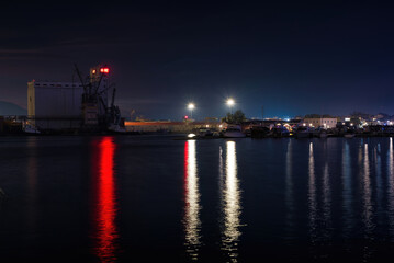 commercial port of Volos at night with nice reflections. Volos, Greece