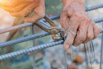 Workers are using steel wire to bind steel bars for foundation structures in the chemical plant...