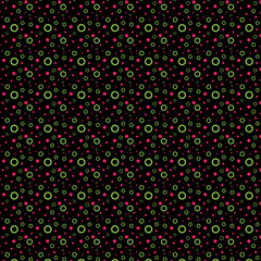 Geometric pattern of bright pink, green polka dots and rings isolated on a black background