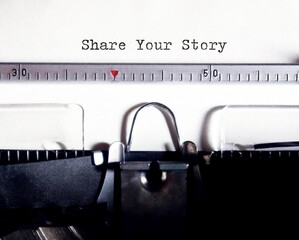 Paper clip with text written SHARE YOUR STORY, means to reveal personal story to the world or story...