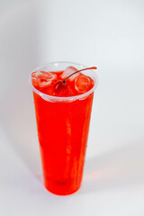 Cherry lemonade in a tall glass with ice and cherries