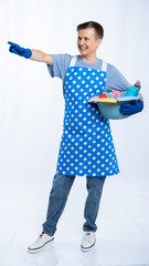 man in blue apron, rubber gloves, blue t-shirt, jeans. the housekeeper holds a basin with...