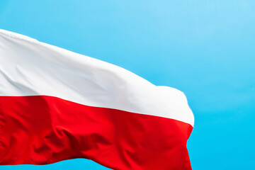 Poland flag waving on blue background