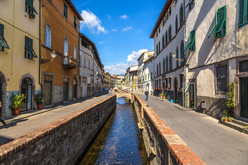 Lucca, Italy. Picturesque river channel with bridges in a medieval town - obrazy, fototapety, plakaty