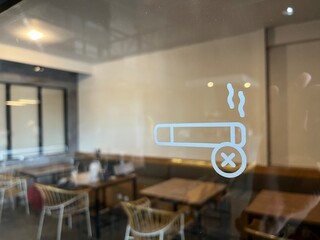 No smoking sign painted on the window with minimalist design.