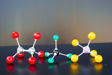 Simulate Shape of covalent molecules on black background. Soft and selective focus.