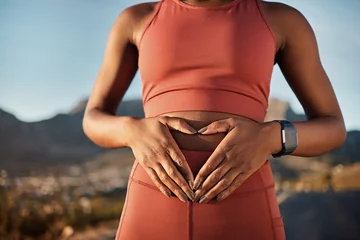 Fotobehang Woman, nature fitness or hands on stomach in diet wellness, body healthcare or abs muscle growth in workout training or sunrise exercise. Zoom, sports athlete or person, belly digestion or strong gut © C Malambo/peopleimages.com