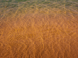 Background of an abstract summer banner Surface texture of transparent beige clear water with...