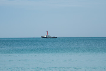 View of a pilot's boat sailing in the blue ocean sea with a foam wake