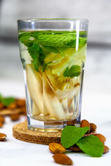 Tea with almonds, pear and mint in a glass