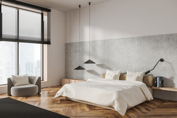 Stylish bedroom interior with bed and armchair near panoramic window. Empty wall