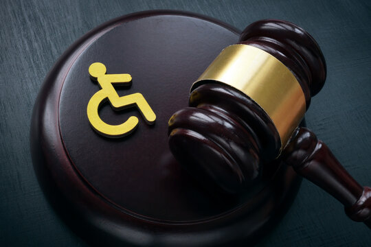 Disabled person sign and gavel. Accessibility law concept.