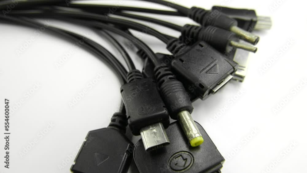 Poster many different connectors for charging push-button smartphones on a white background camera movement