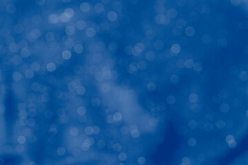Brurred backkground of shine dark blue fabric texture
