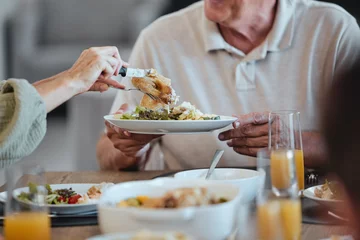 Foto op Plexiglas Oude deur Plate, food and thanksgiving with a meal in the hands of a senior man during a family lunch for celebration. Party, health and social with a group of people eating together in the holiday season