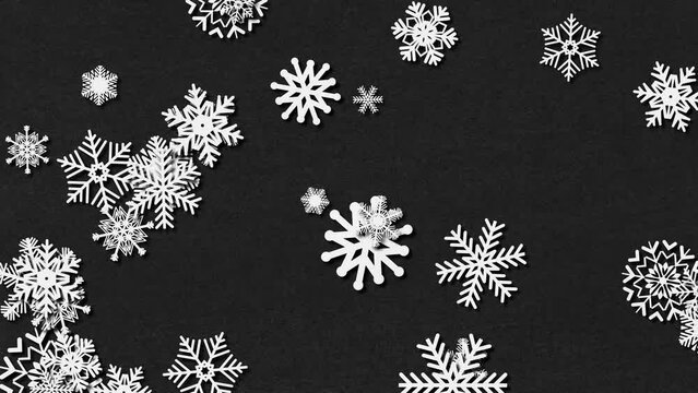 Paper snowlakers on black paper background. Loop 30-seconds