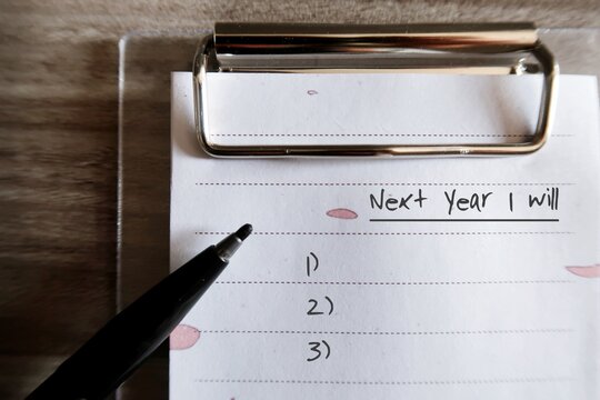 Black Pen, White Paper Note Clipping With Clipboard With Text Written NEXT YEAR I WILL , Concept Of New Year Resolution - Goals Setting To Change For Better Or Improve Oneself In The Next Year To Come