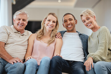 Family, portrait and relax in living room home, bonding and having fun. Interracial love, diversity and care of happy grandparents, man and woman, smiling and enjoying quality time together in house.