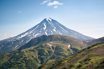 Fototapeta premium Summer landscape. Vilyuchinsky volcano against blue sky. Kamchatka peninsula