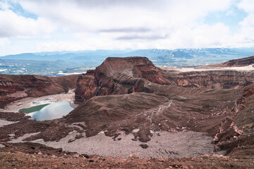 Emerald lake in the crater of the volcano. Summer landscape, Kamchatka peninsula