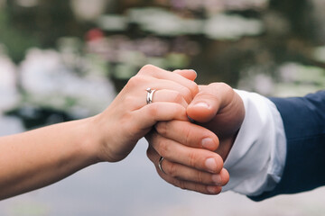 Couple holding hands during wedding photo session
