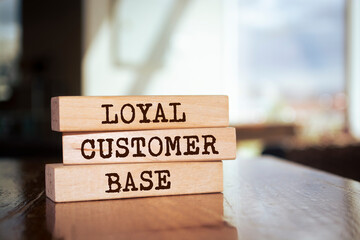 Wooden blocks with words 'LOYAL CUSTOMER BASE'.