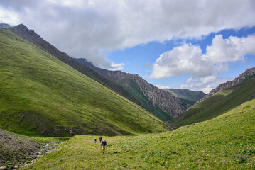 Fototapeta na wymiar Trekkers on the epic Heights of Alay route, Alay, Kyrgyzstan