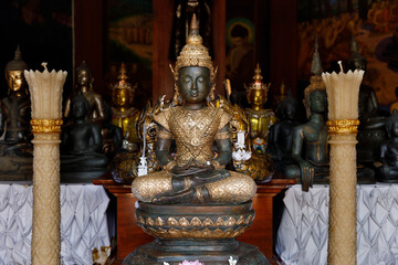 Phu Ruea District, Loei Province, Thailand - 28 July 2022: Bronze Buddha statue wearing golden clothes at Wat Somdet Phu Ruea Ming Mueang Temple