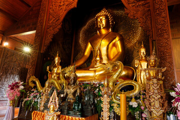 Phu Ruea District, Loei Province, Thailand - 28 July 2022: Golden big buddha meditating in church at Wat Somdet Phu Ruea Ming Mueang