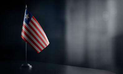 Small national flag of the Liberia on a black background