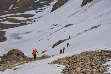 Trekkers descending the Jiptick Pass on the epic Heights of Alay trek, Alay, Kyrgyzstan