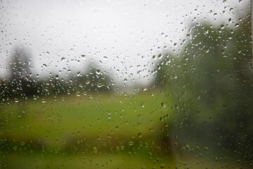 Waterdrops on window informs of nature landscape 