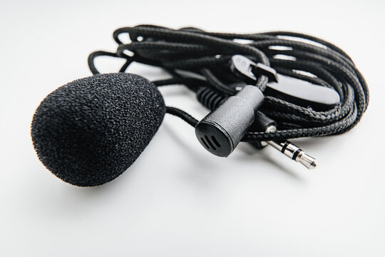 Buttonhole on a white background. Compact microphone for audio recording.