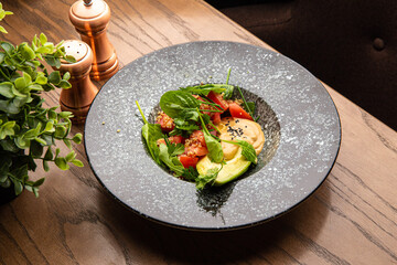Salad with tomatoes and avocado with sauce