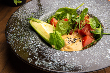 Salad with tomatoes and avocado with sauce