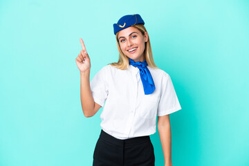 Airplane stewardess Uruguayan woman isolated on blue background showing and lifting a finger in sign of the best