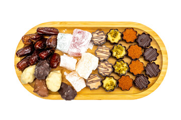 Valentine's Day Wooden tray with sweets, dates, figs, chocolate, handmade nougat caramel. Festive background for Tu Bishvat Rosh Hashanah la'Ilanot.