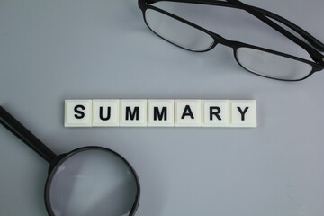 glasses and magnifying glass with summary words. summary concept or data obtained