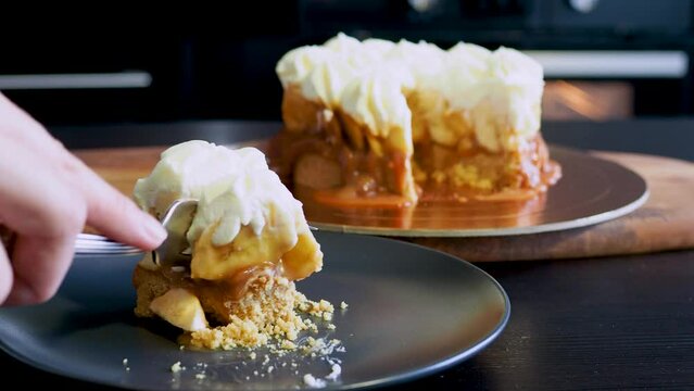 Banoffi cake made of shortbread, bananas and homemade caramel, cake with bananas, caramel and cream , cut a piece