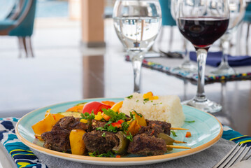 Shish kebab a la carte meal with rice at table setting