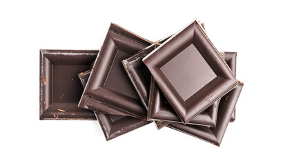 Dark chocolate pieces, cubes on a heap, broken chocolate isolated on white background, top view