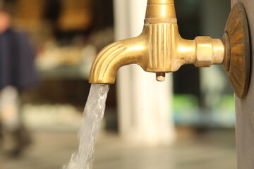 A tap with tiny water coming out of it