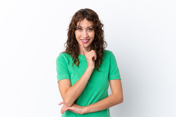 Young woman with curly hair isolated on white background showing a sign of silence gesture putting finger in mouth